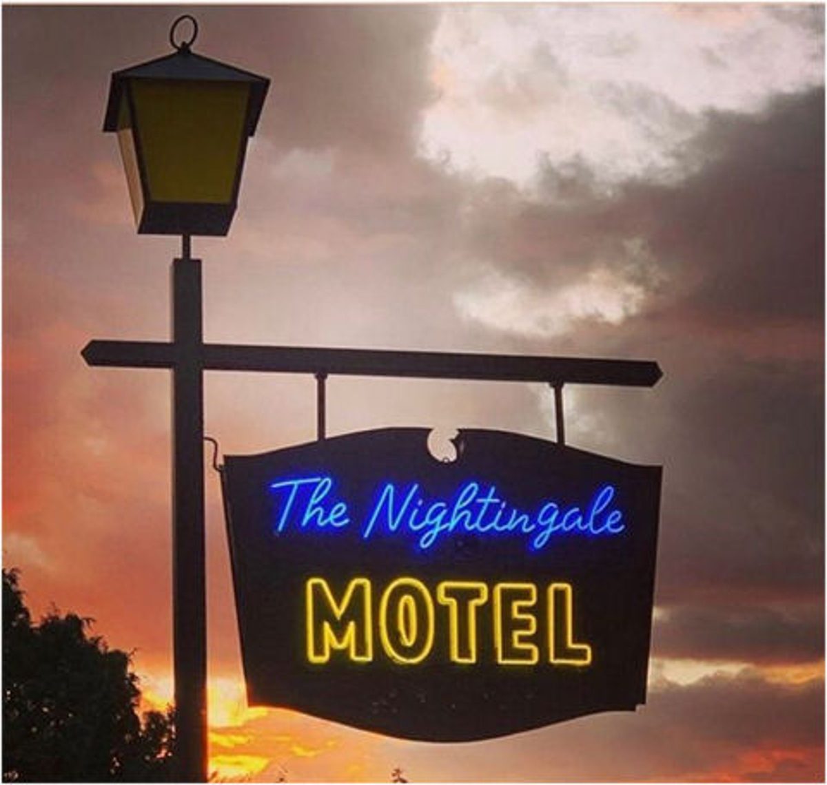 Vintage Nightingale Motel neon sign glowing at sunset