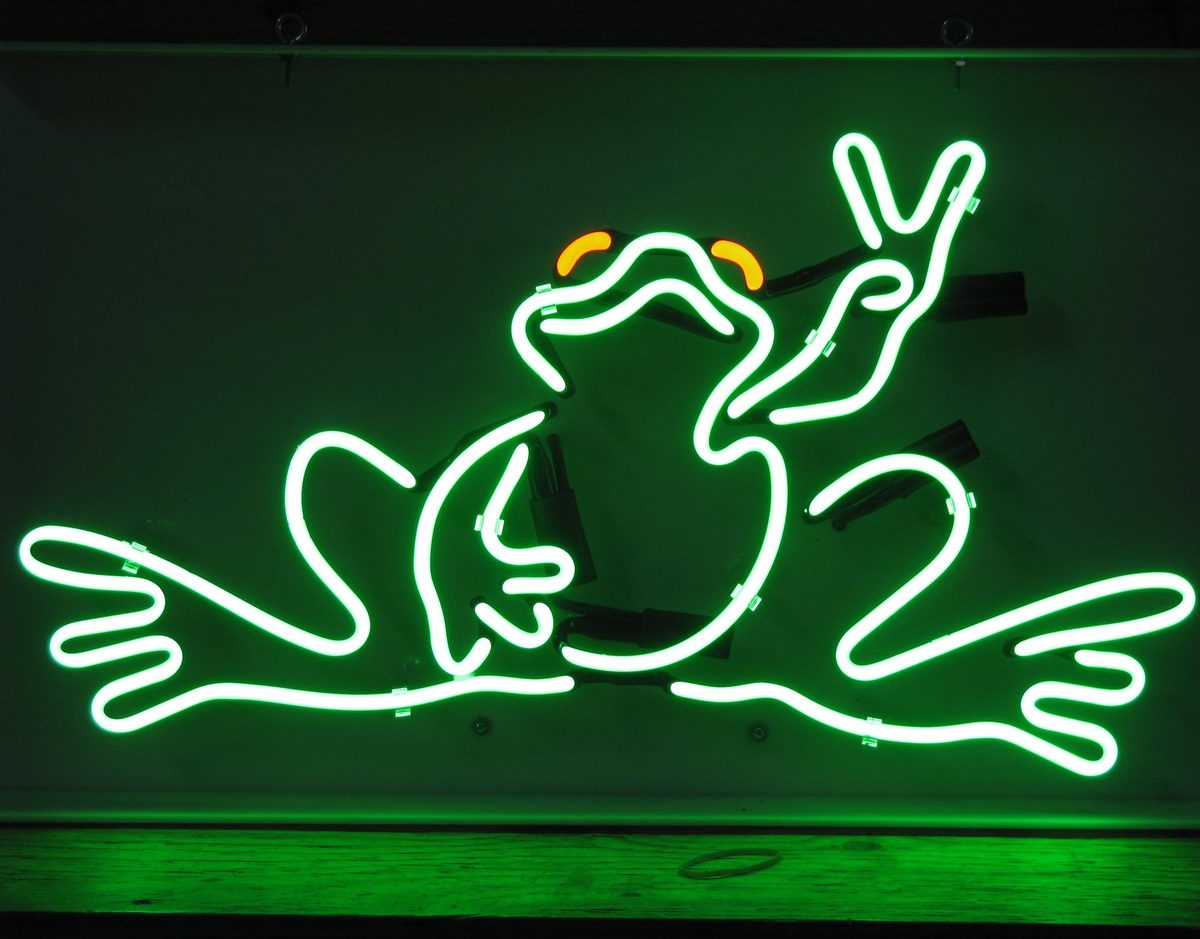Green neon frog character flashing a peace sign